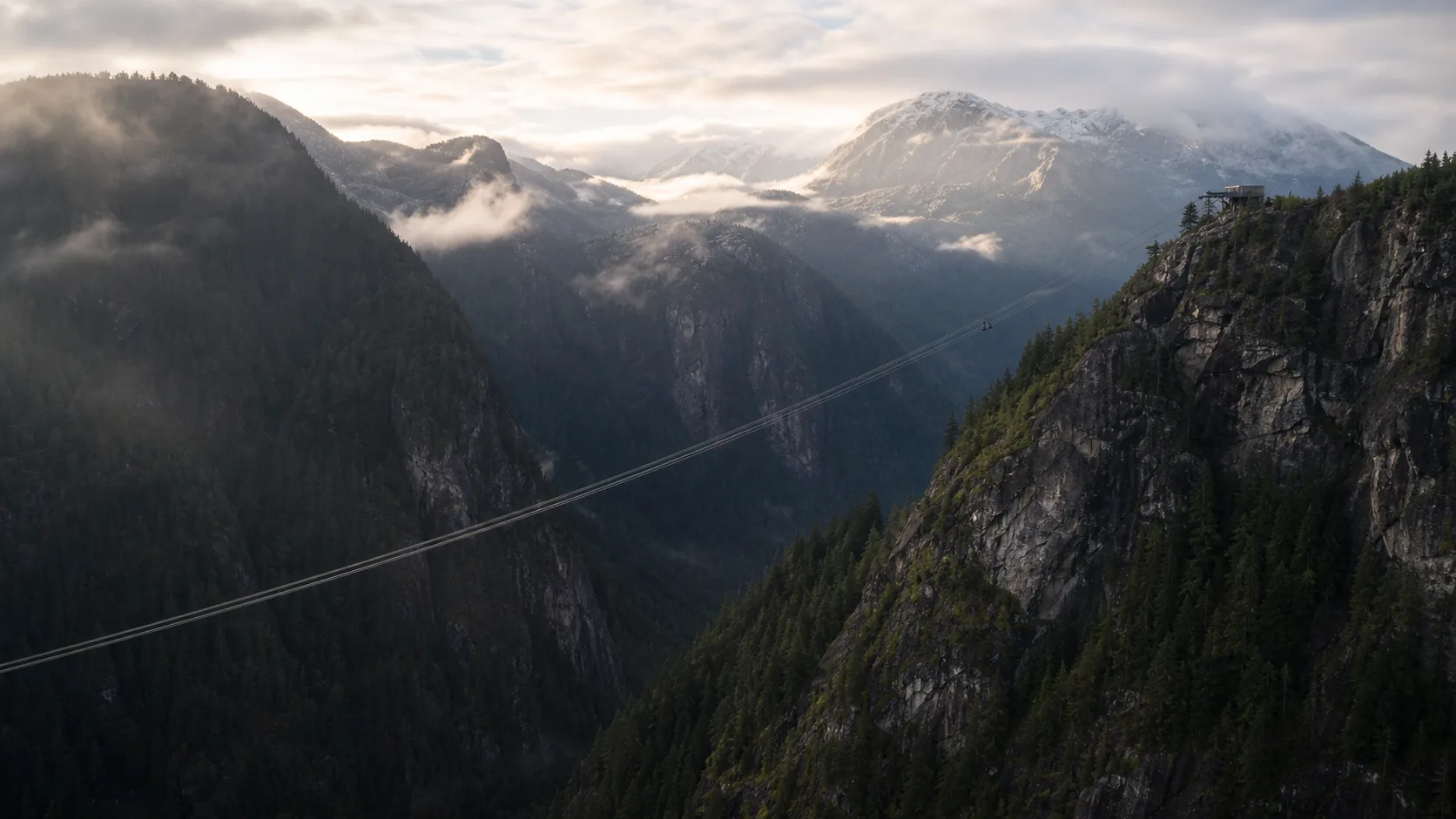 An expansive mega zipline crossing a dramatic mountain valley